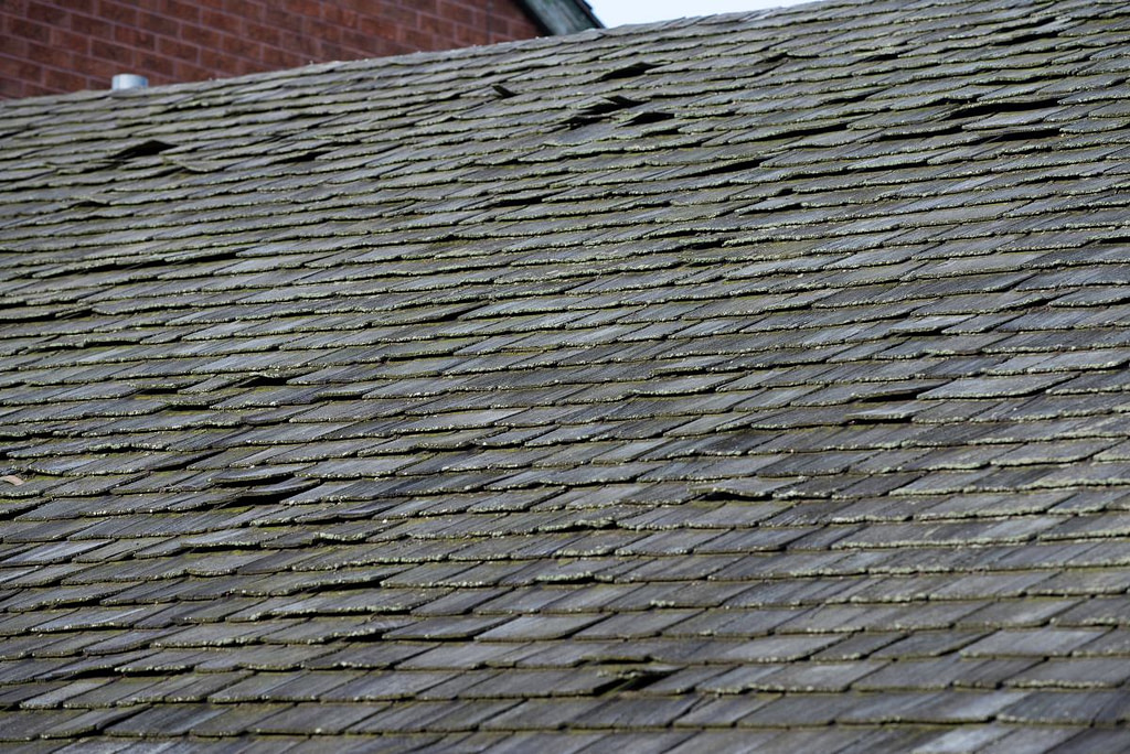 old and broken asphalt shingles