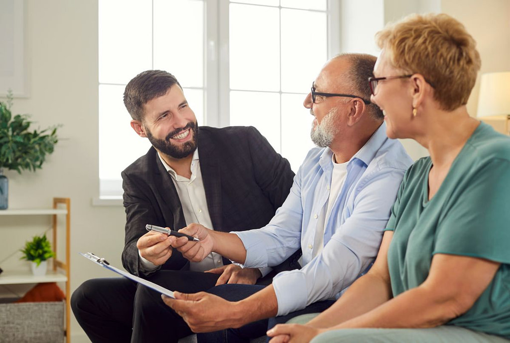 commercial roof warranty consultation with old couple