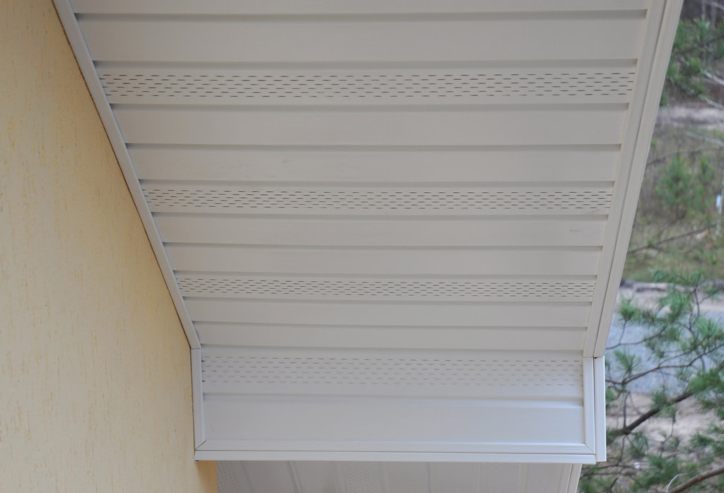 vinyl soffit installation Plastic white uPVC soffit board below the facia of the roof