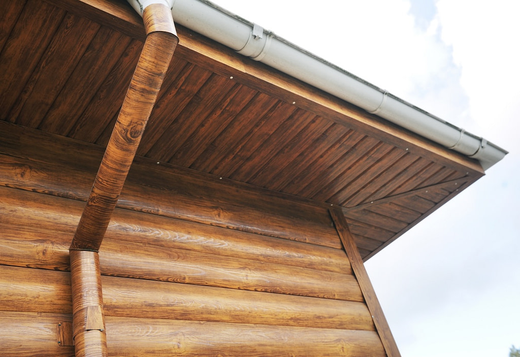 Wood roof overhang with metal roofing material on top