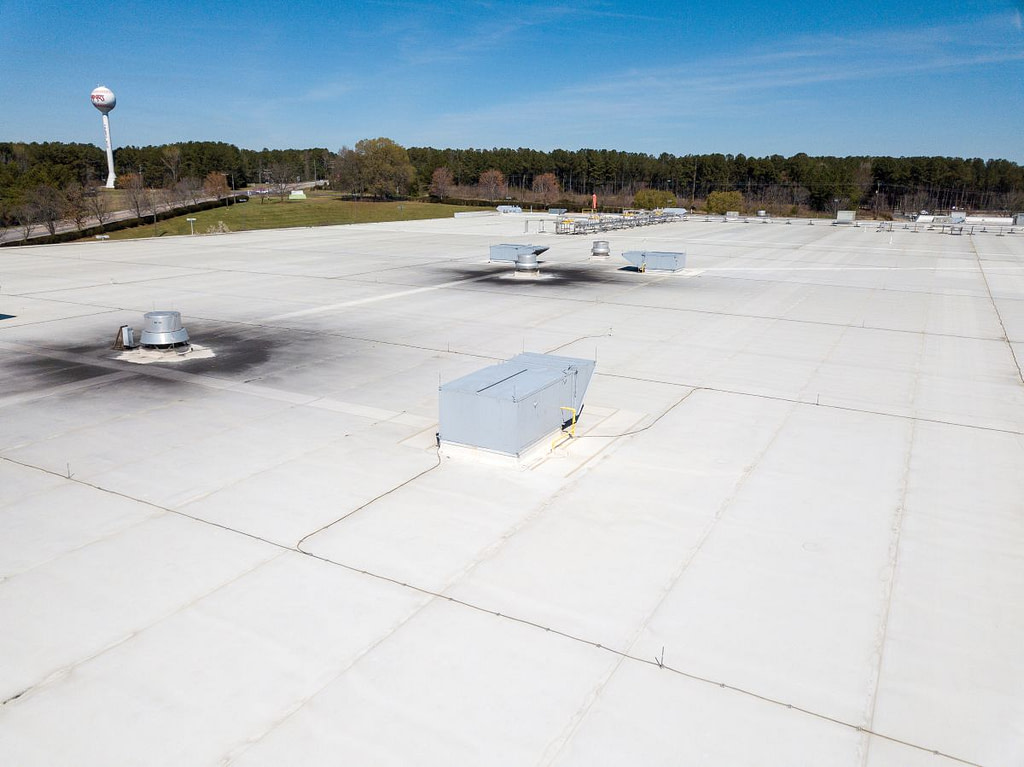 white flat commercial roof that needs to be replaced
