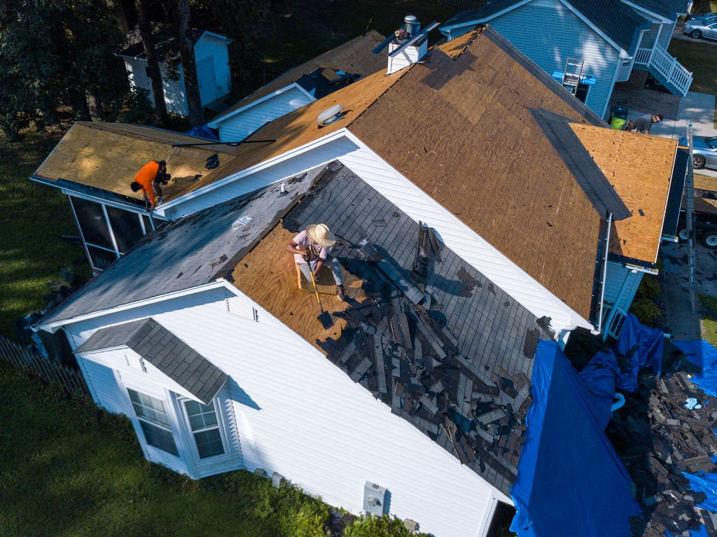 A Residential Roofing Crew In The Process Of Replacing A Roof