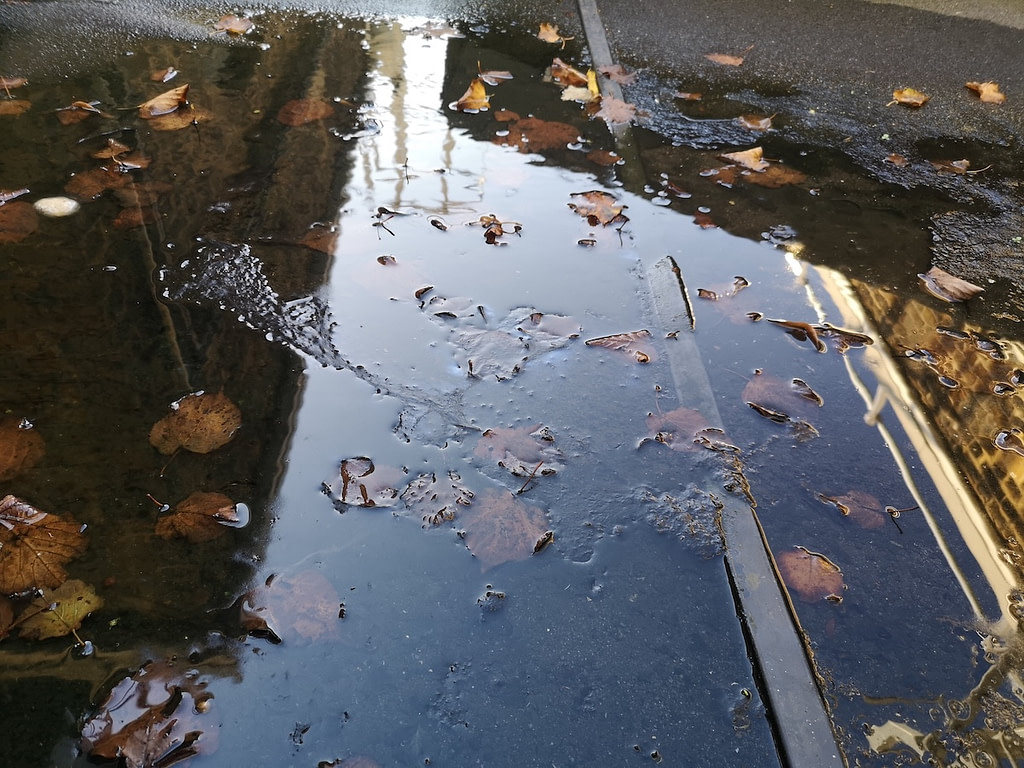 pooling water on flat roof causes leaks and water damage
