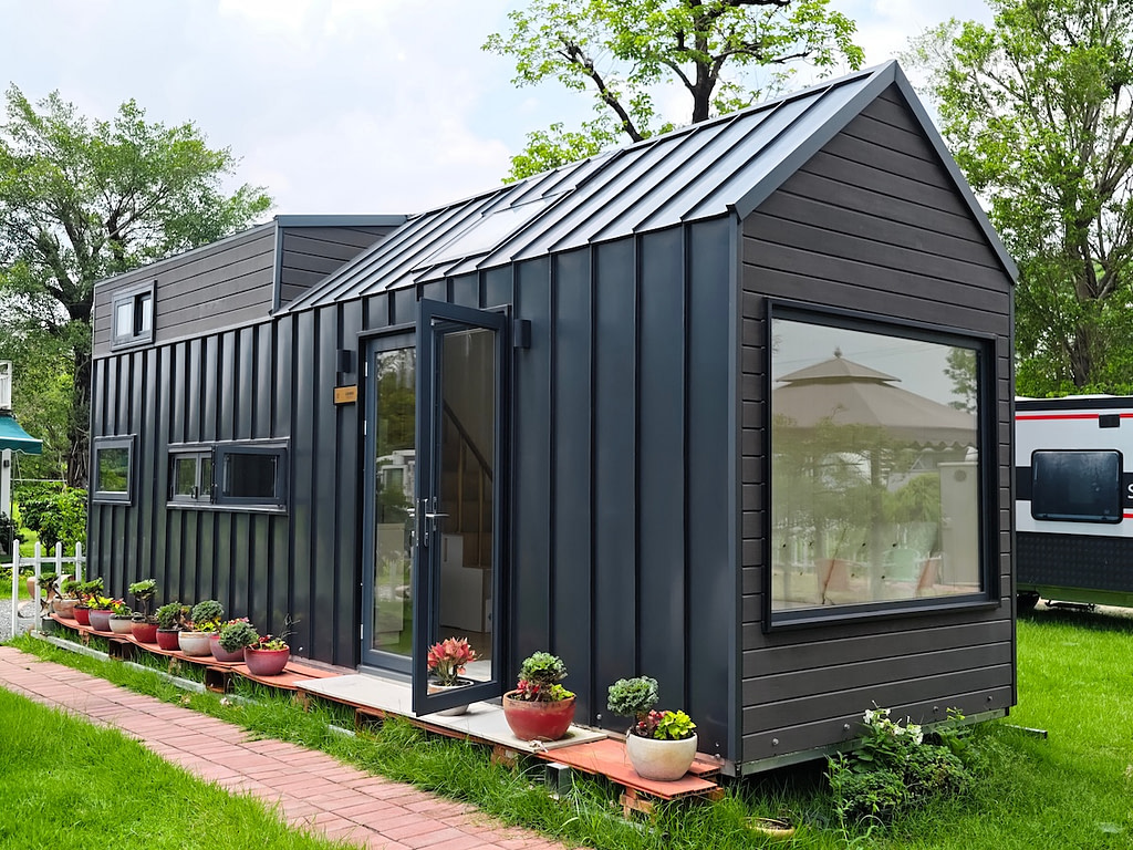 Modern tiny house with metal siding and roof