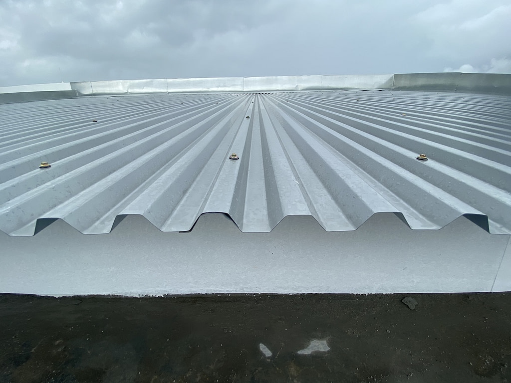 Close up of a corrugated metal deck roof system just installed on a building