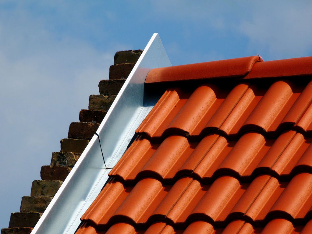 close-up of a clay tile roof with metal flashing