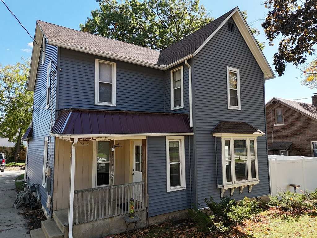 Newly installed dark vinyl siding