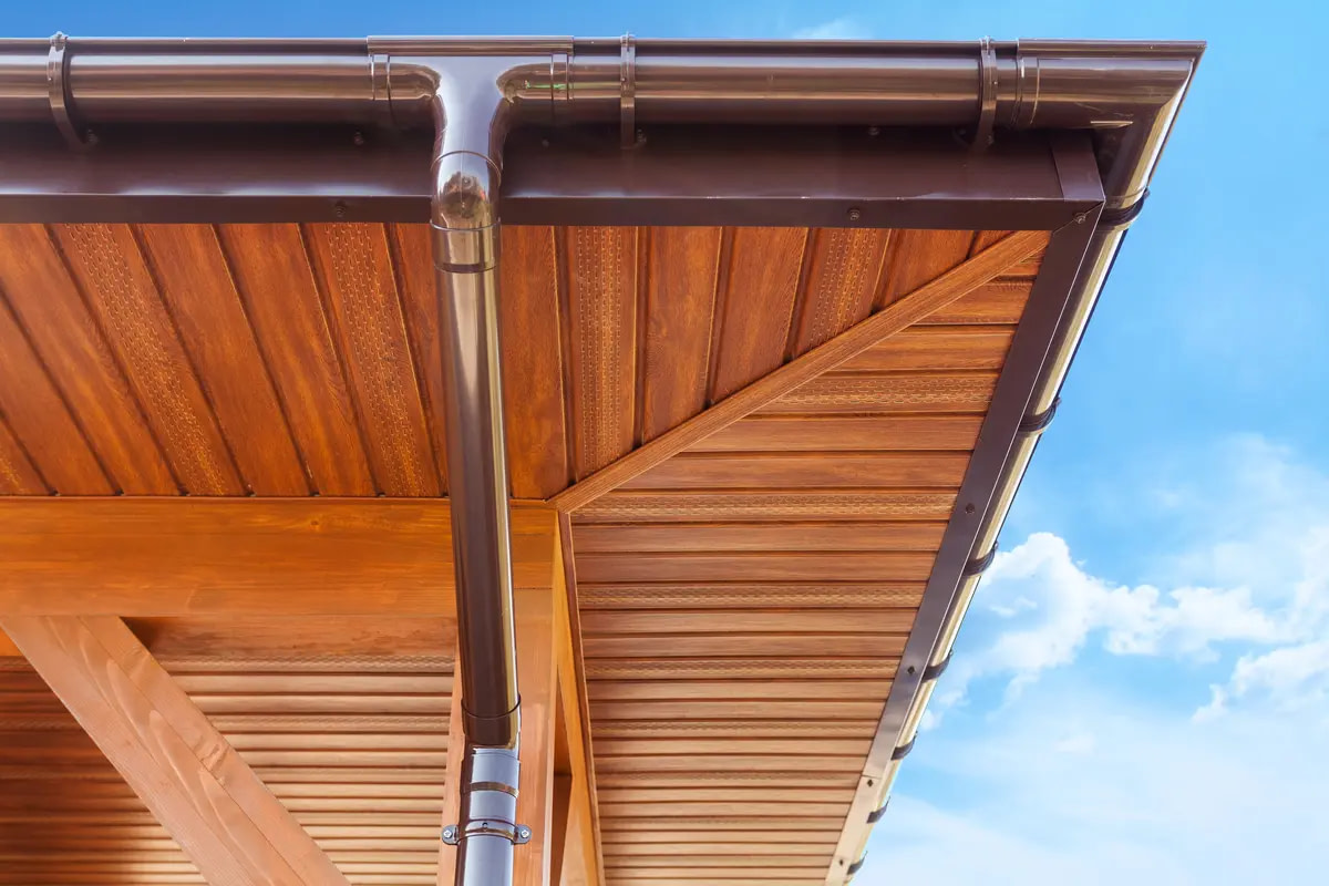 brown gutters and wood underside of a roof