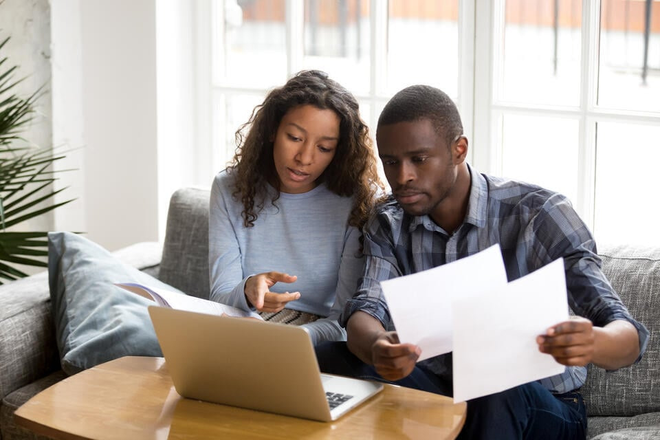 roof financing-a couple checking their financial health on a laptop