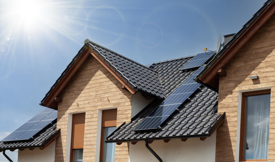 modern roof-solar roof on wood sided house