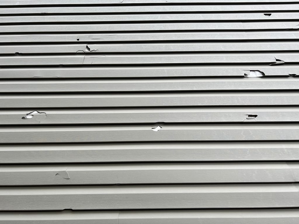 Cracked siding with missing pieces