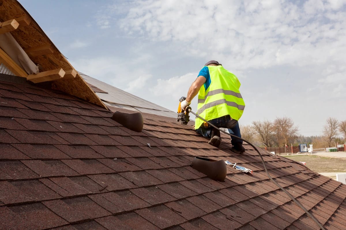 worker repairing the roof