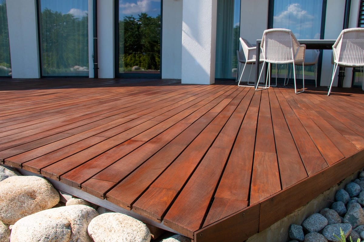 decks molalla-dark wood decking built off the main house with decorative rocks around the edge
