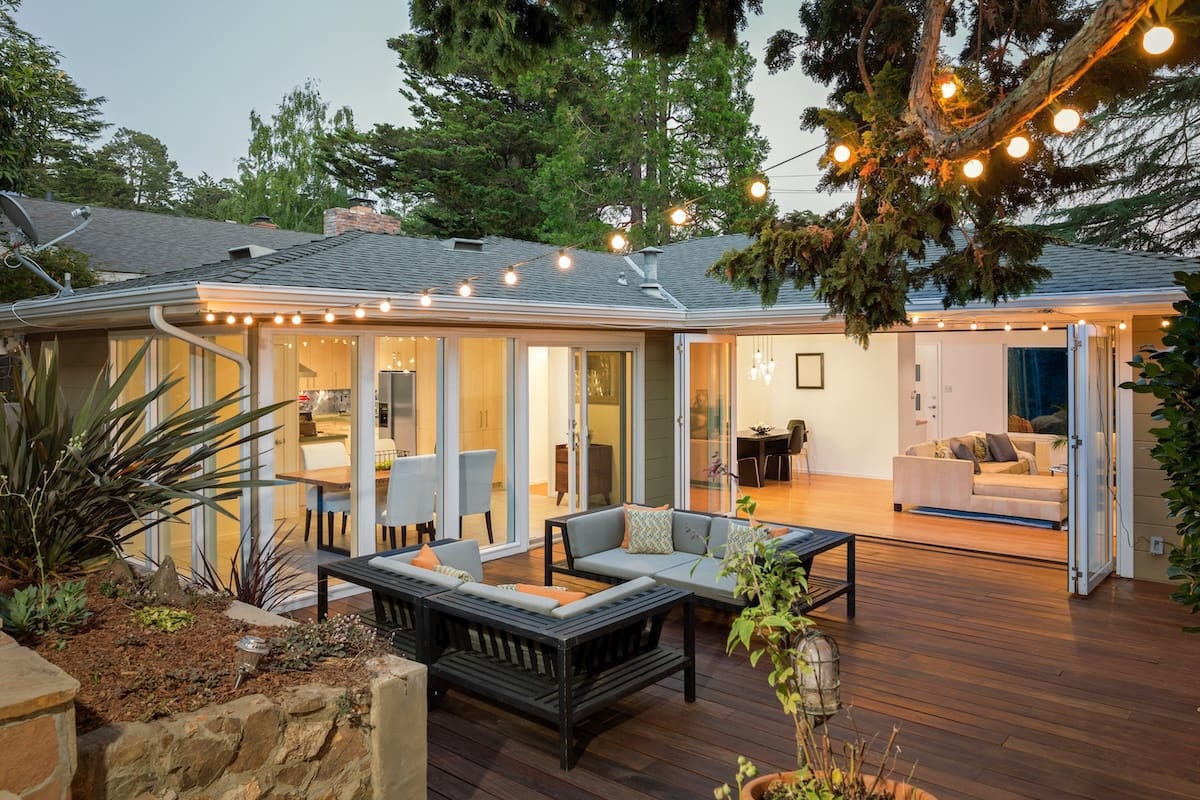 Home with a newly built deck. Furnished and modern with string lights