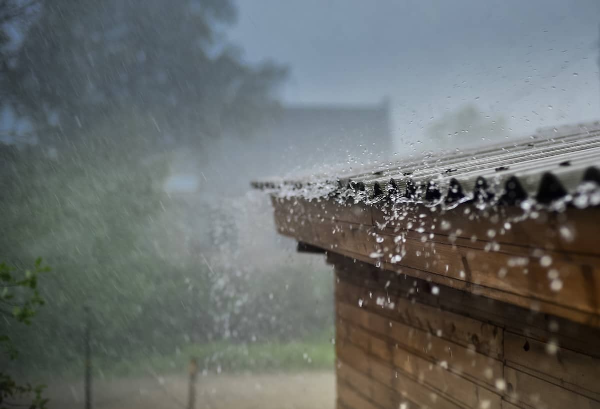 Heavy rain hitting shingles on roof of house