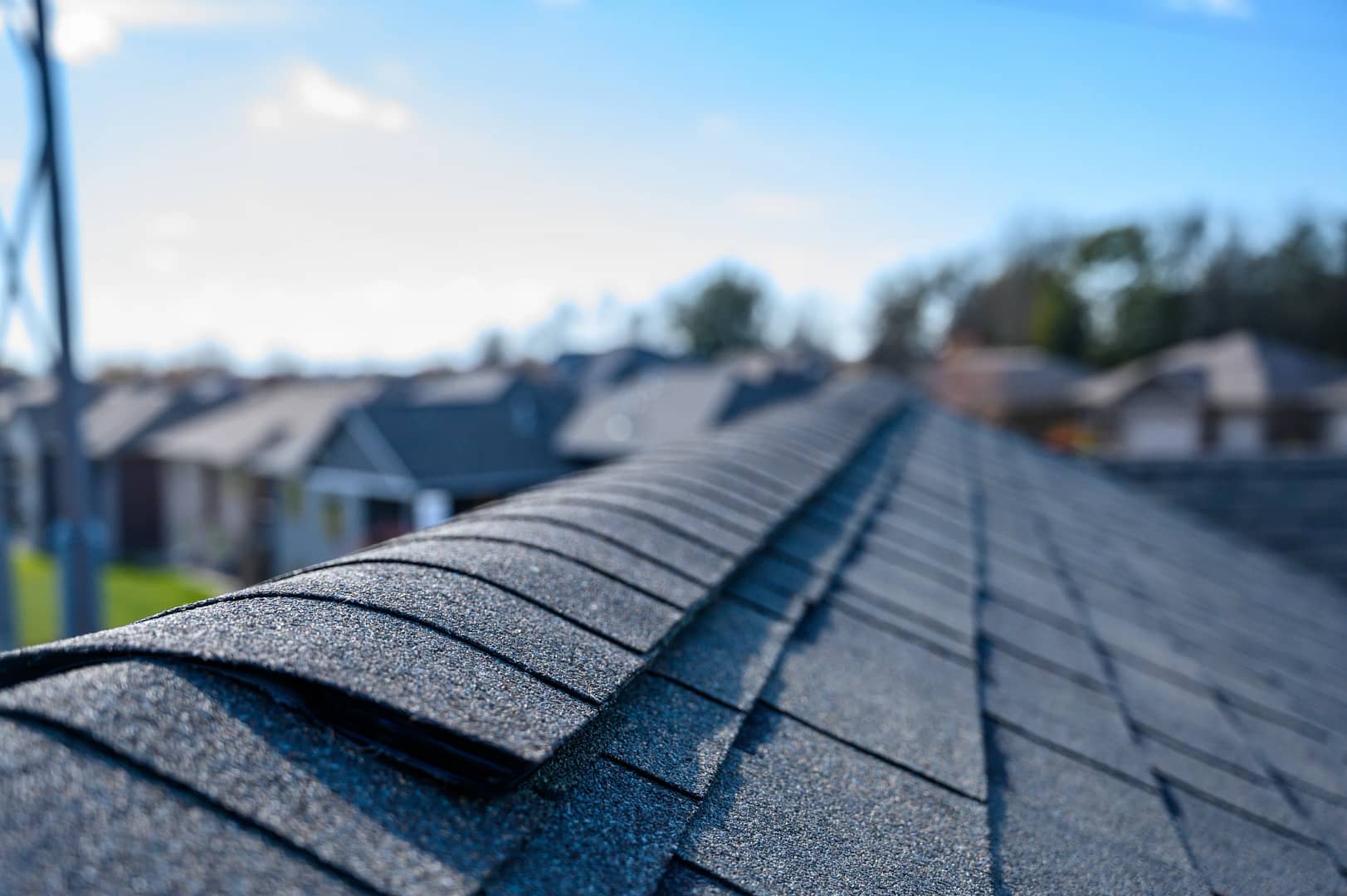 ridge of an asphalt shingle roof in a portland neighborhood