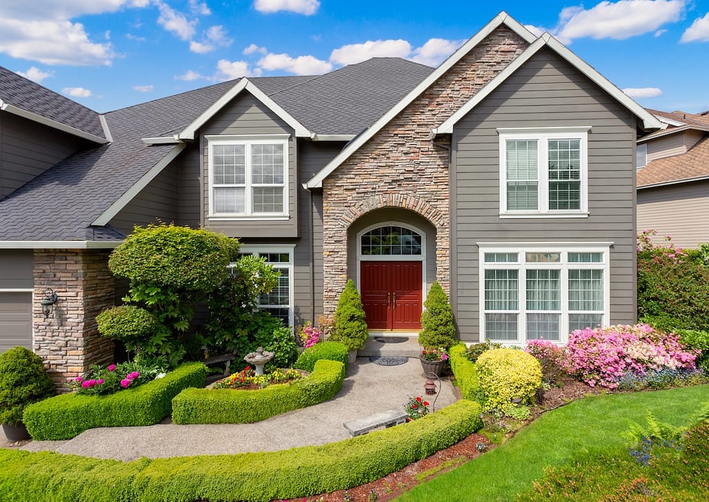 Modern family home with dark siding with accent wall