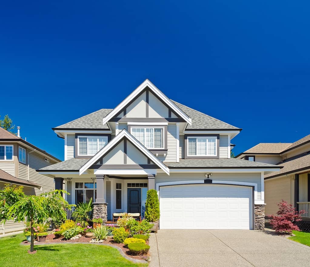 White siding on house with brown accent trim