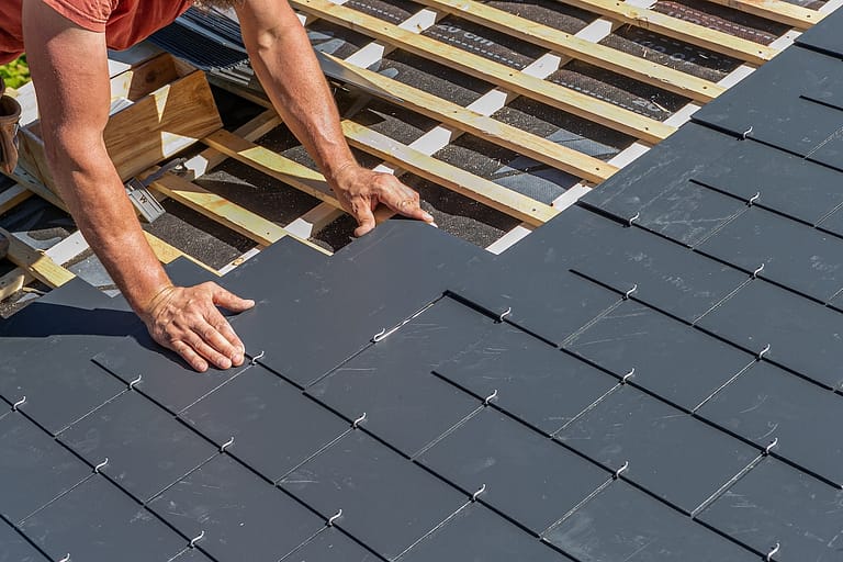 Craftsmen are installing a slate roof