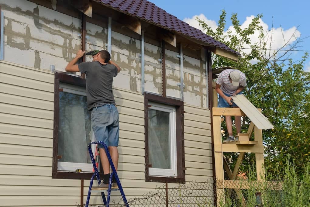 two men working on vinyl siding installation