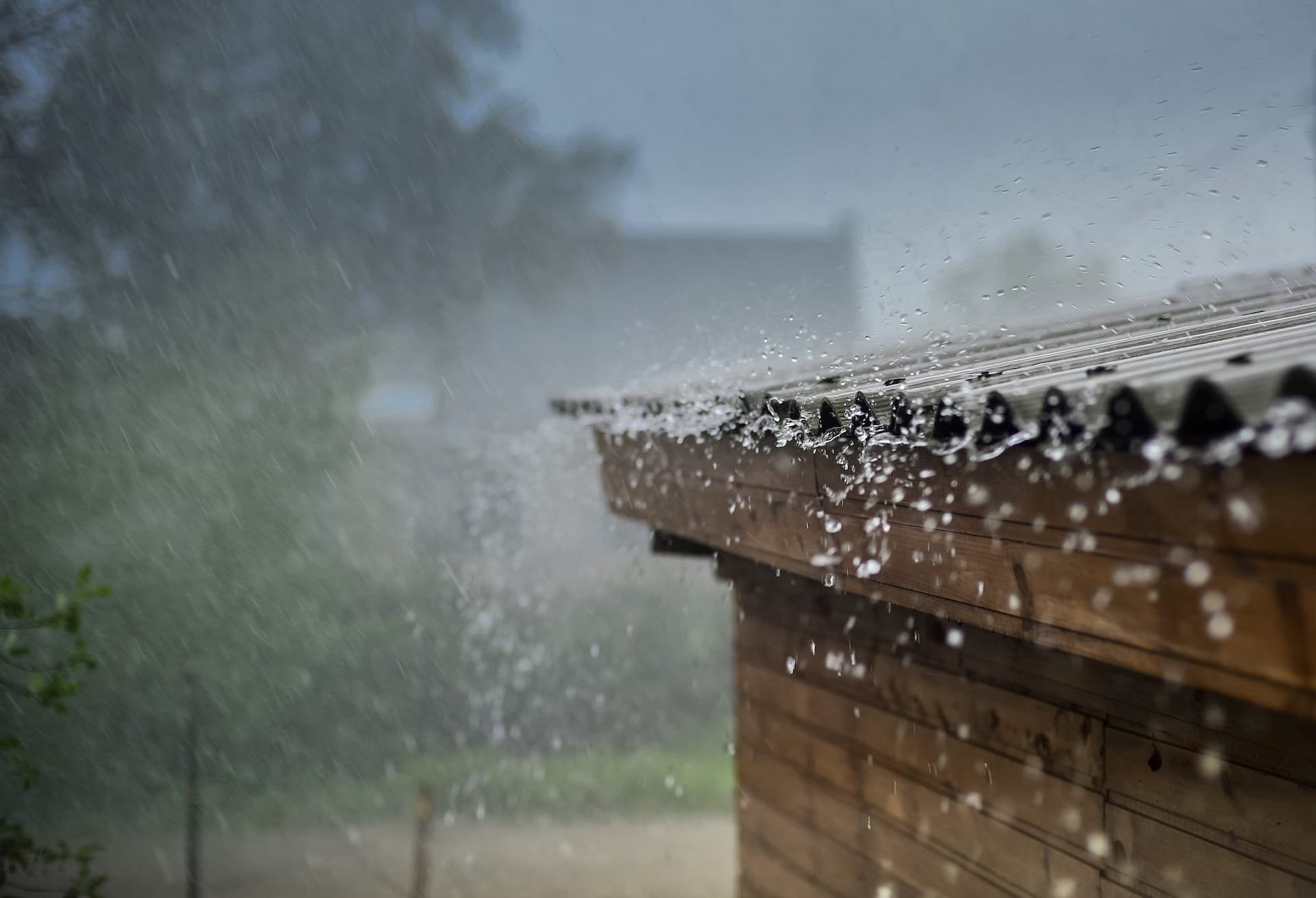 rain and hail fall on brown roof