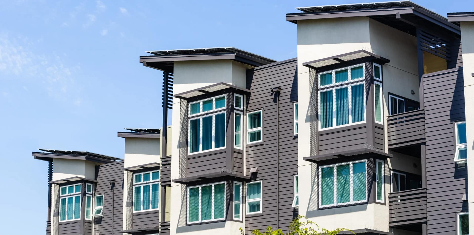 grey and white apartments with windows