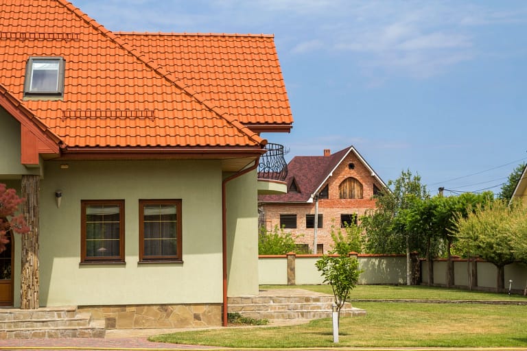 roof inspected house with clay tile roof and yard