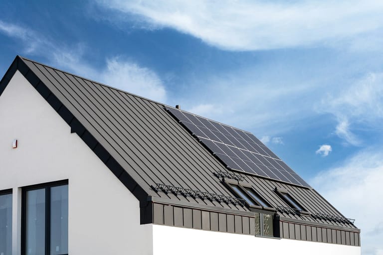 large house with metal roof and solar panels