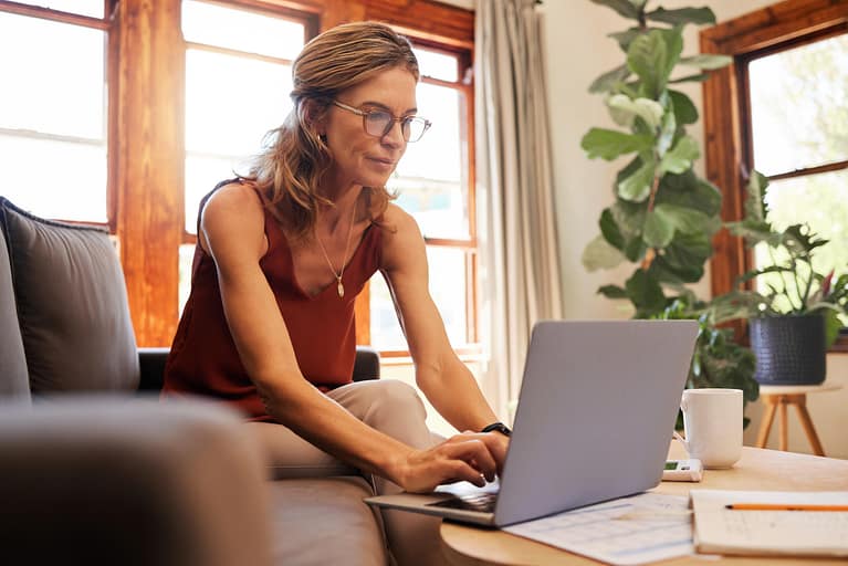 how to pay for a new roof-a woman on her laptop going over her financing options