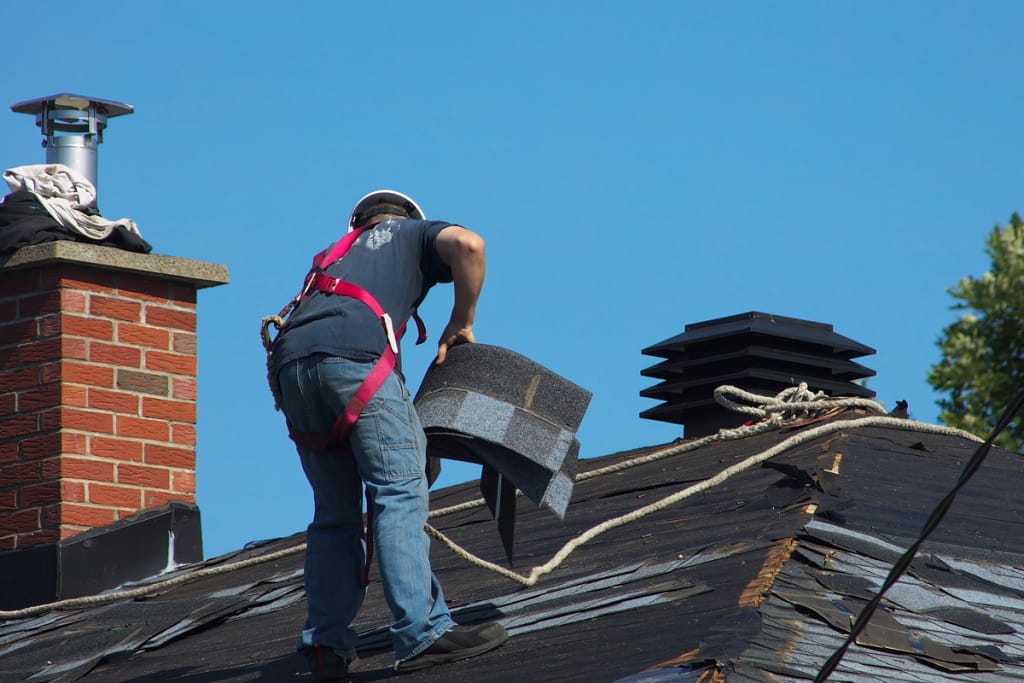 contractor completing roof replacement after storm damage
