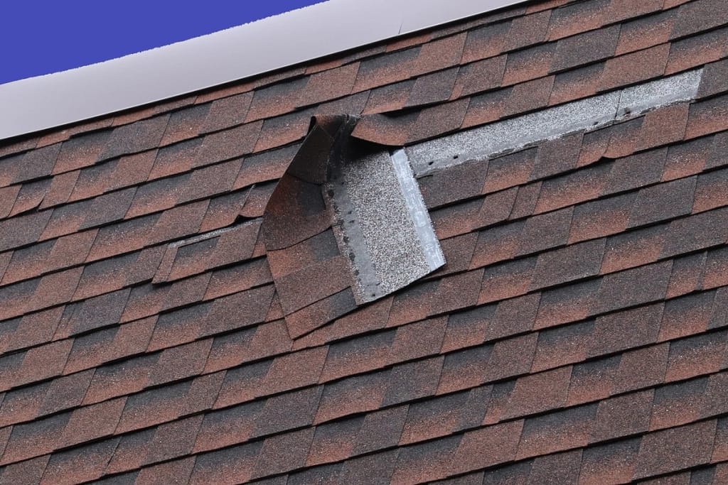 a strip of asphalt shingles that are falling off of the roof