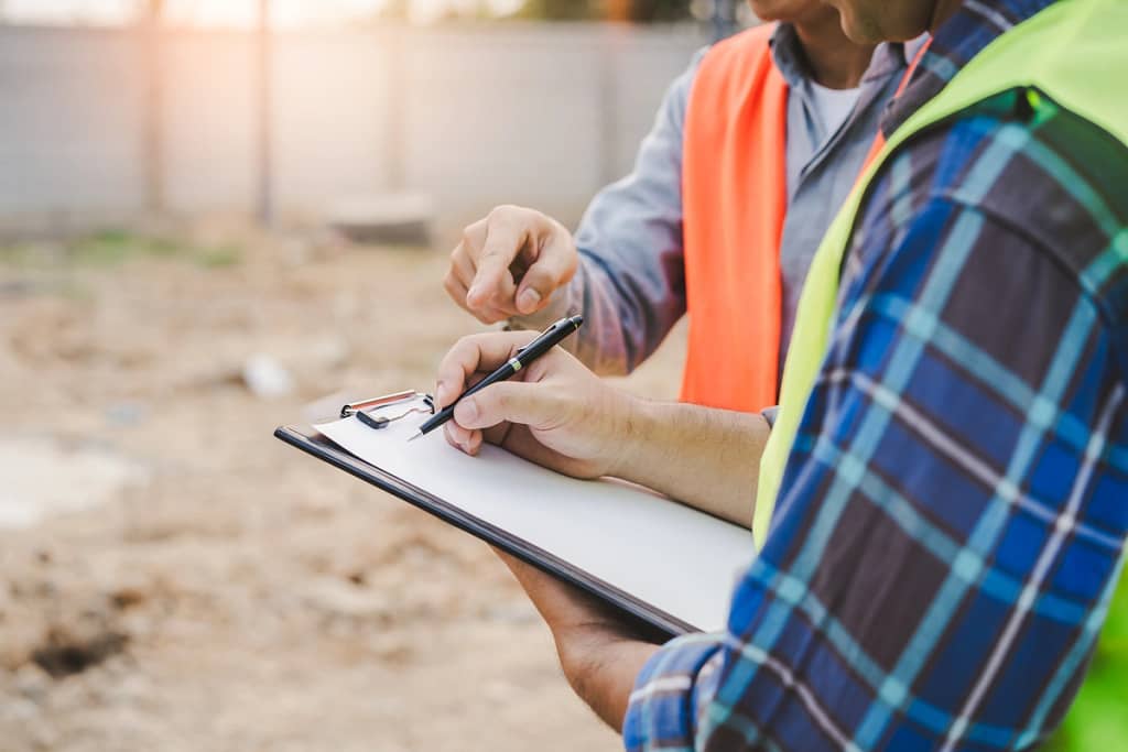 contractors look at a clipboard