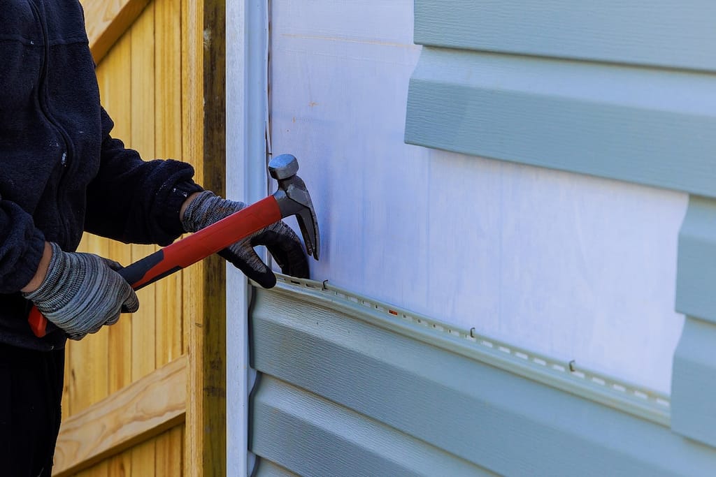 Replacing plastic siding on an exterior wall of a residence house