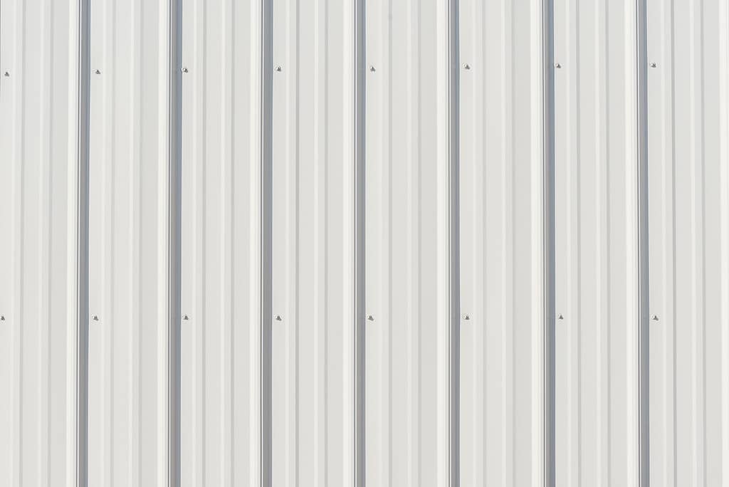 Gray metal siding close up with vertical lines for background