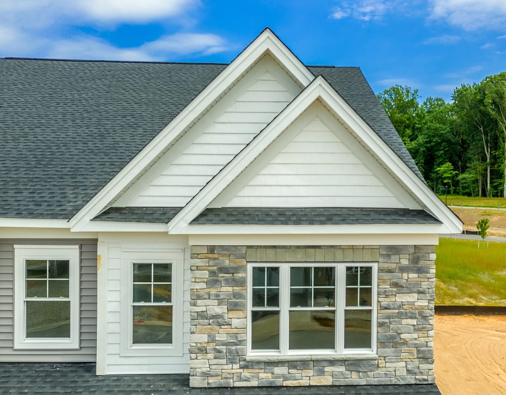 Double gable roof with manufactured stone veneer siding