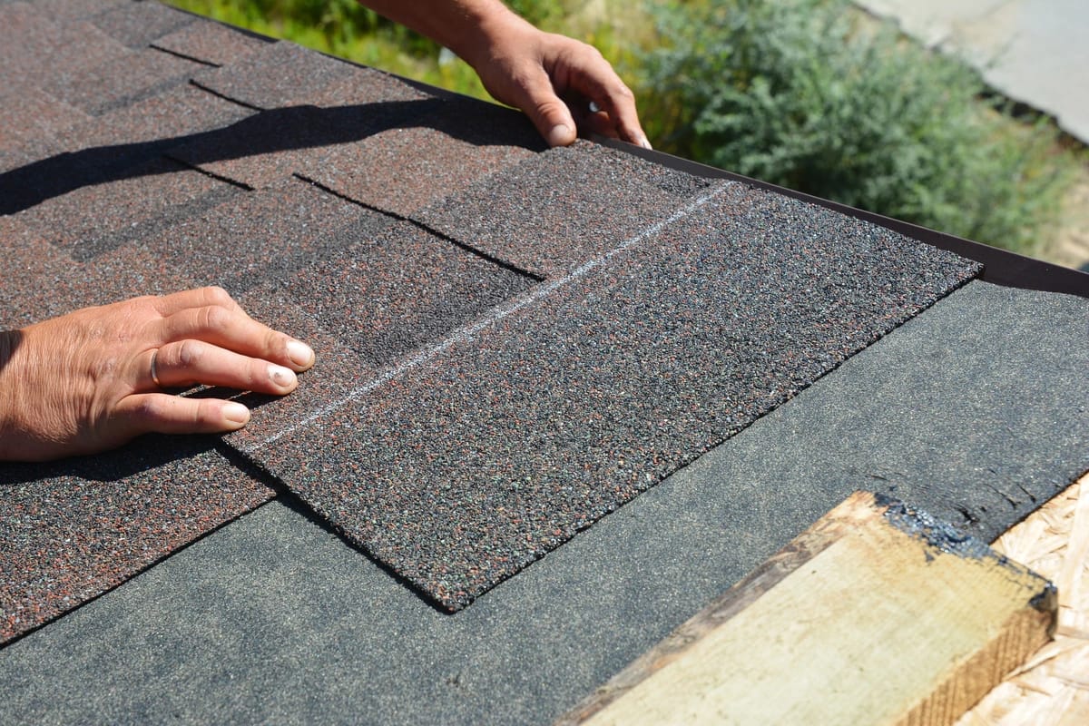 A single asphalt shingle being installed