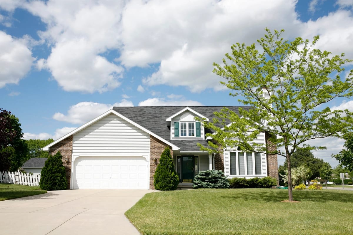 brick and vinyl siding large home