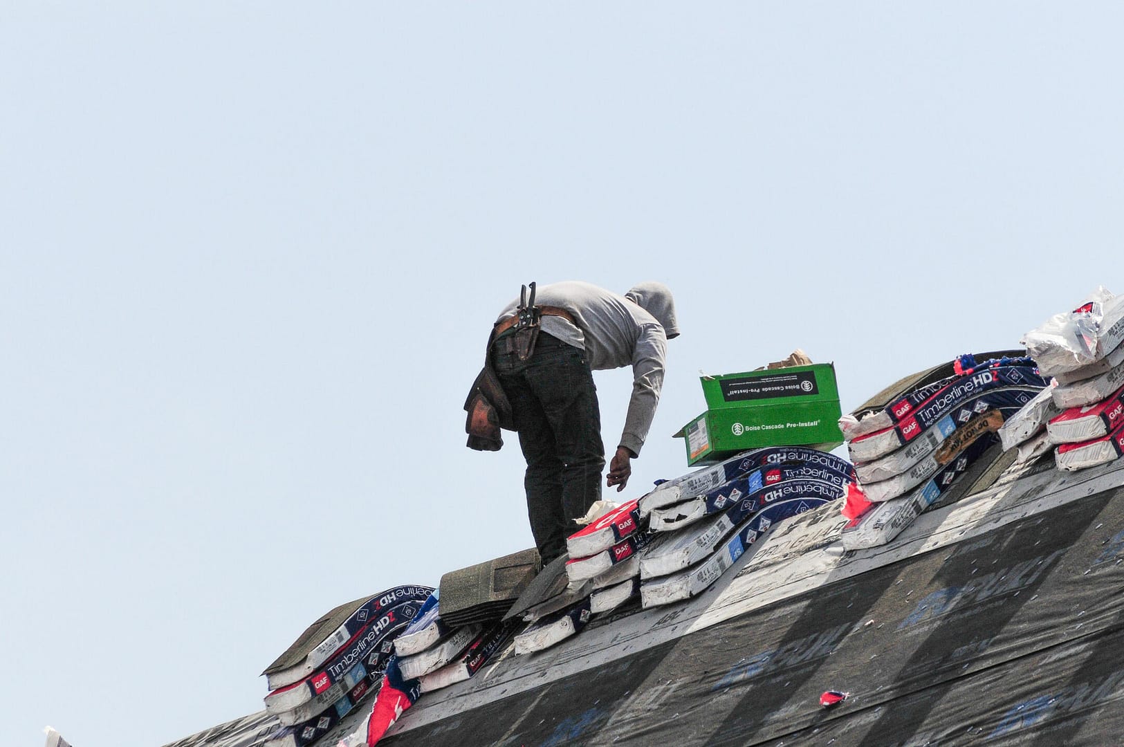 how many shingles in a bundle-roofer working with shingle bundles for roof replacement