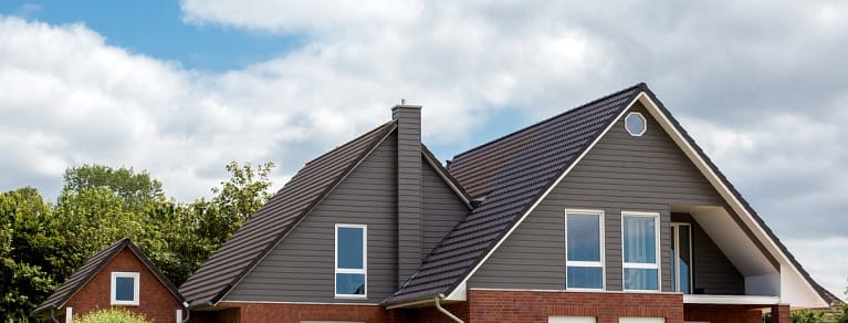 large house with dark roof and beautiful windows