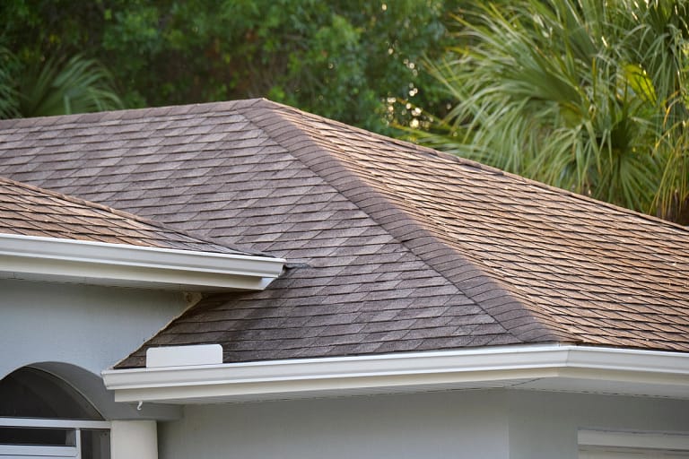 house with waterproof asphalt shingles installed on roof