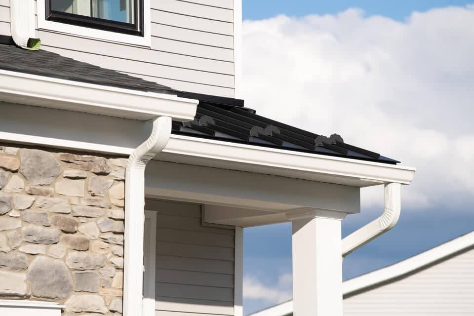 roof eaves-porch overhang on a home with light gray siding