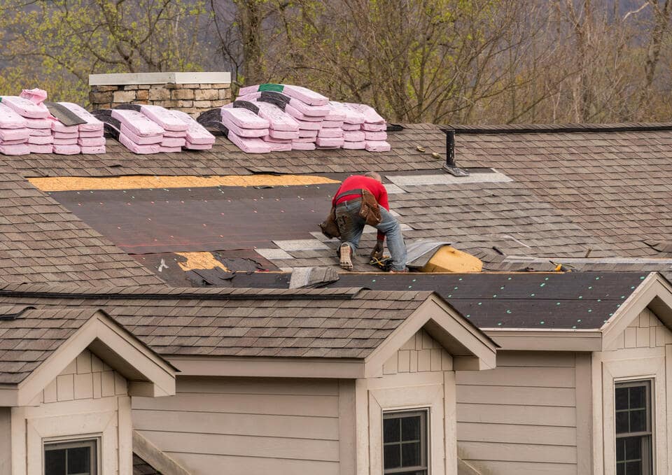 roofing materials list-roofer replacing shingles on a roof
