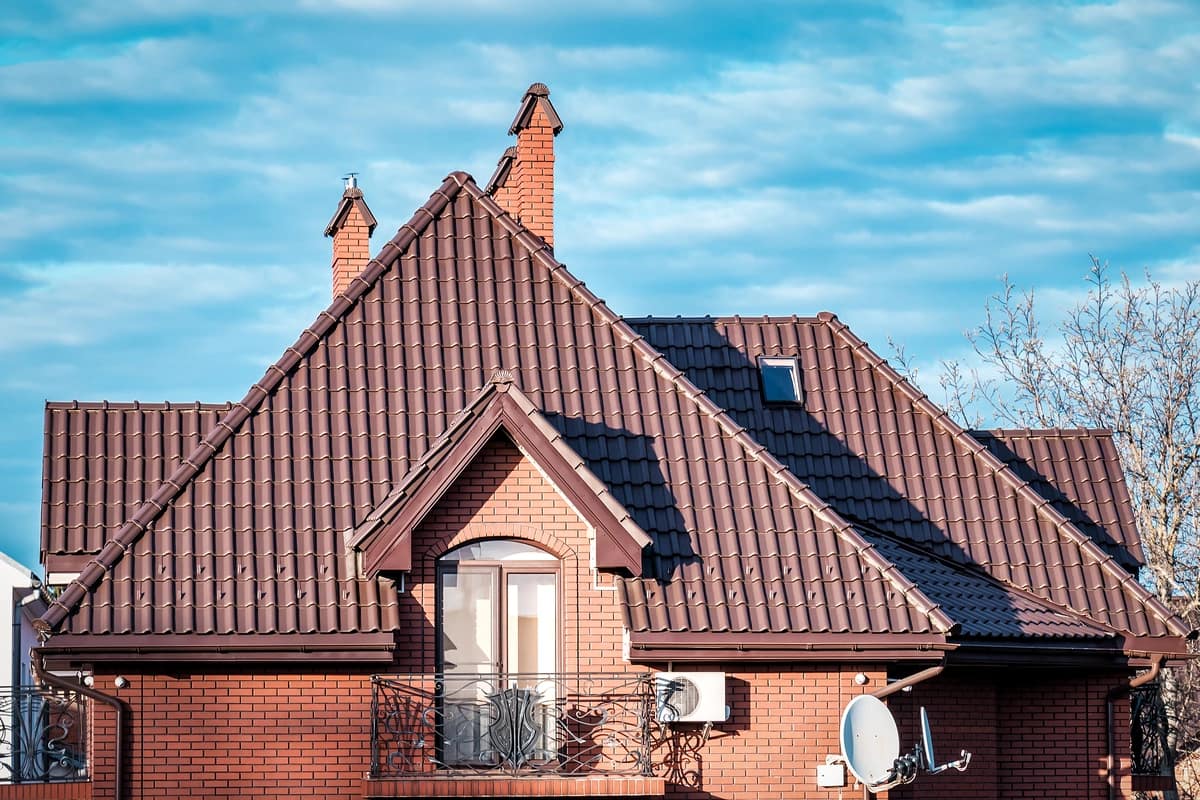 brick house with brown metal tile roof