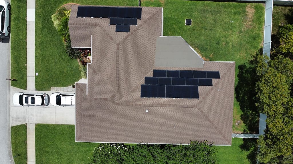 Aerial drone photo of solar panels on shingle roof of modern family