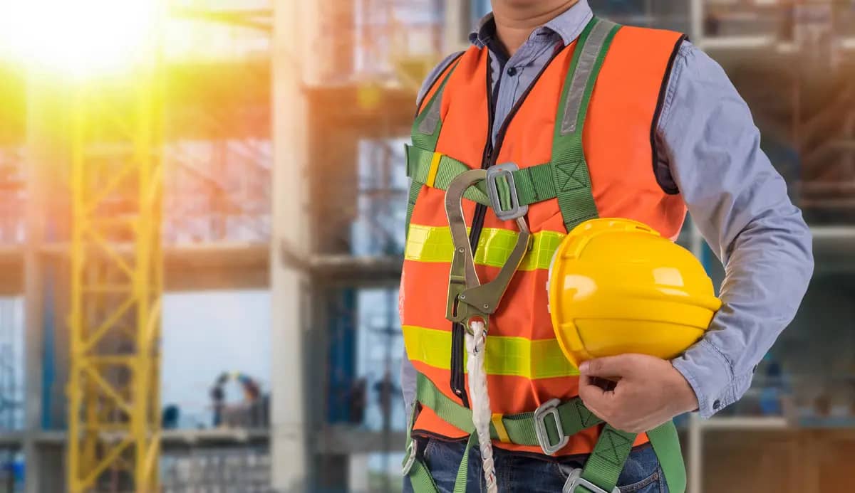 holding a hard hat