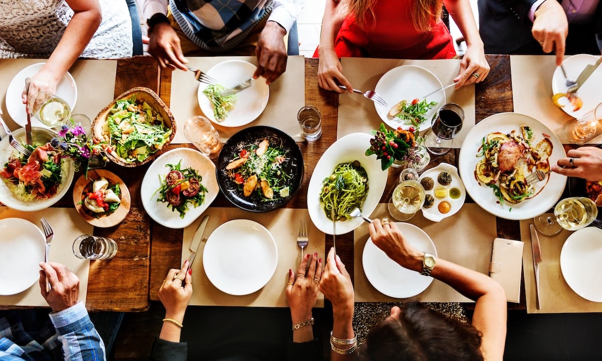 Aerial view of a larger dinner party with full plates