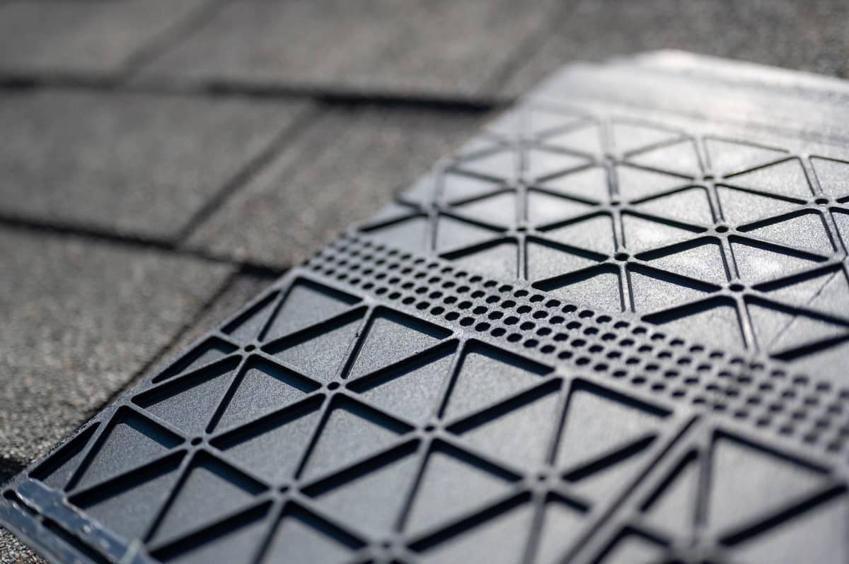 Underside of a synthetic roof shingle that is hail and wind resistant.