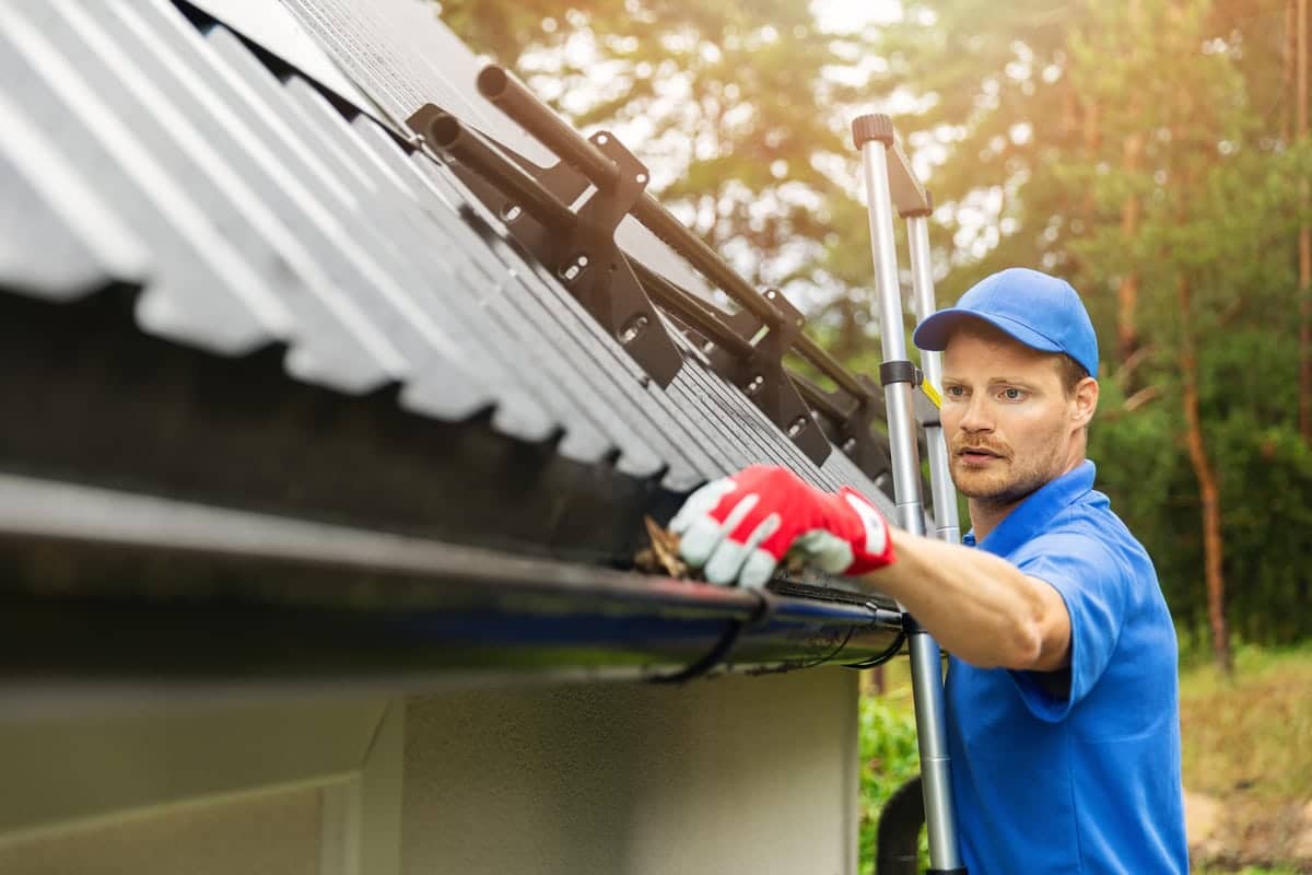 a worker installing a gutter