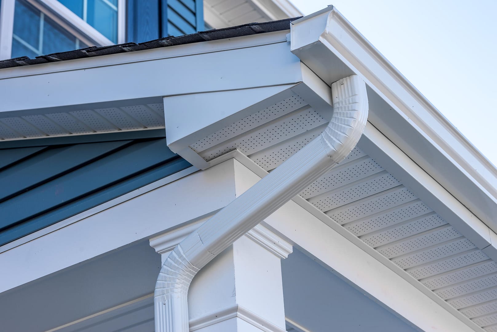 gutter colors-white gutter system on blue sided house