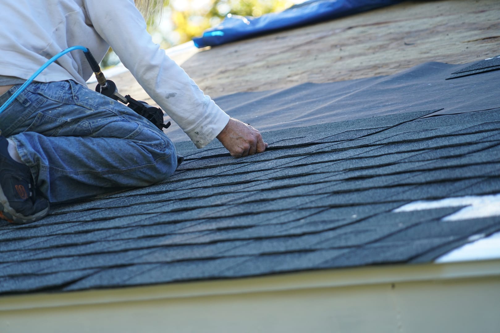 close up of roofing contractor hired when homeowners decide to replace roof